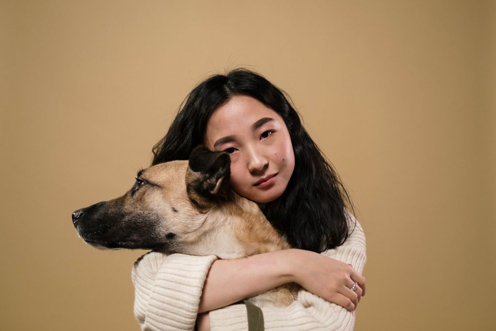 Woman hugging a dog - it's important to educate pet owners
