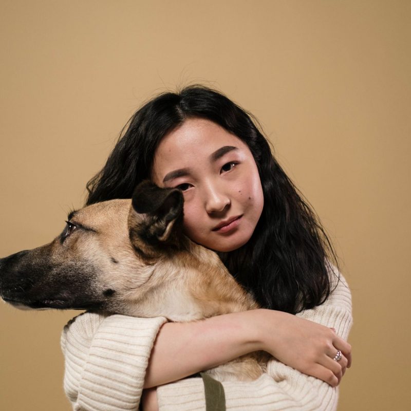 Woman hugging a dog - it's important to educate pet owners
