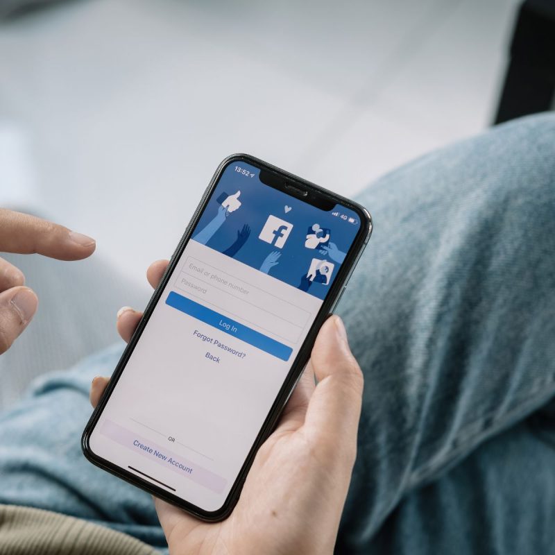 Smartphone displaying facebook login- social media is important for pet businesses