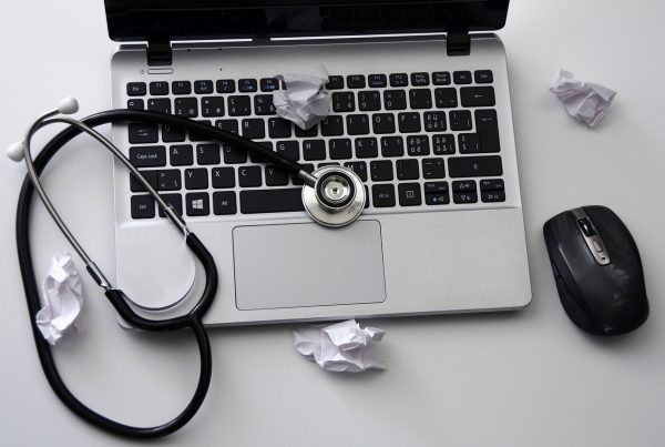 A stethoscope sitting on a laptop to depict how vets can be an animal copywriter