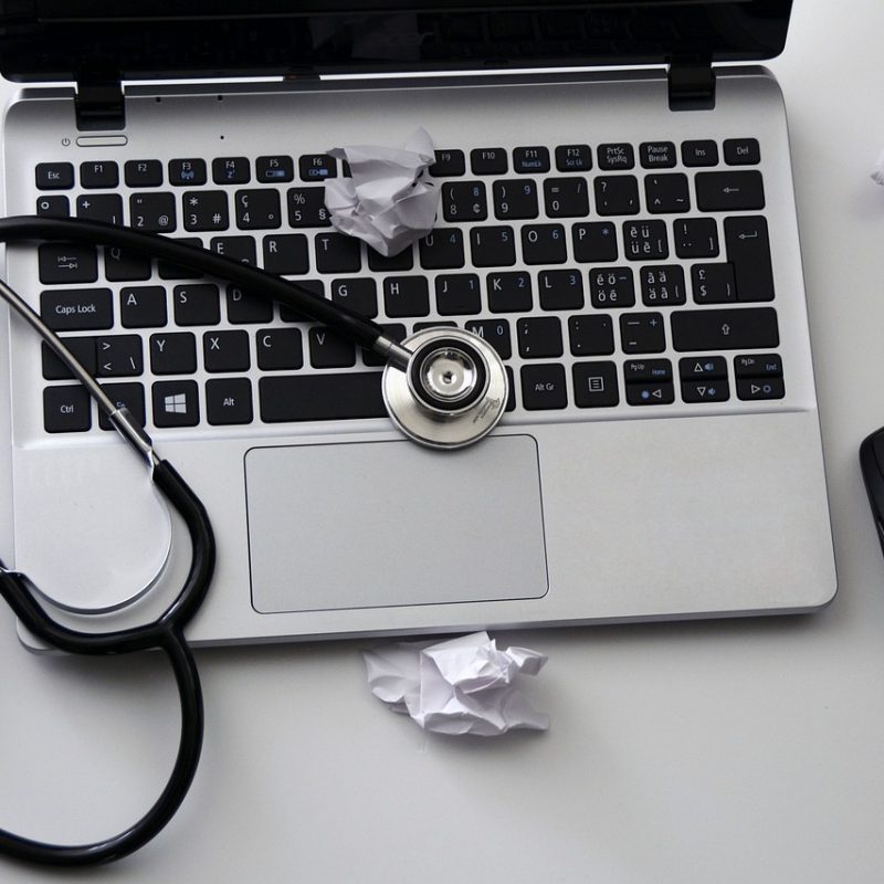 A stethoscope sitting on a laptop to depict how vets can be an animal copywriter